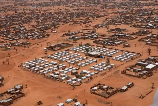 FILE- An aerial view shows a camp of internally displaced people in Djibo, Burkina Faso, May 26, 2022. Videos published by the state-run RTB Television Tuesday, Nov, 28, 2023, showed large groups of people riding motorcycles around a swathe of desert land as they appeared to be running from aerial bombardments. It was not immediately clear the number of civilians and security forces killed during the Sunday attack near Mali's border and involving about 3,000 rebels, according to the broadcaster.