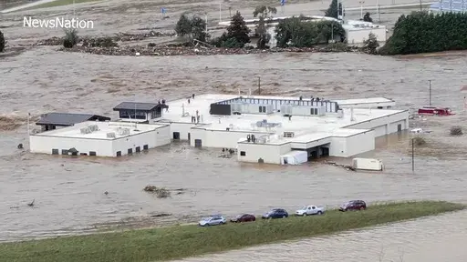 In this image made from a video provided by NewsNation, people can be seen on the roof of the Unicoi County Hospital in Erwin, Tenn., on Friday, Sept. 27, 2024. (NewsNation via AP)