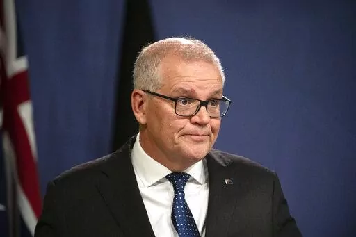 Former Australian Prime Minister Scott Morrison speaks during a news conference in Sydney, Wednesday, Aug. 17, 2022. Morrison defends his decision to secretly appoint himself to five ministerial roles when he was Australia's prime minister, saying it was a necessary step during the depths of the coronavirus crisis. (AAP Image/Flavio Brancaleone)