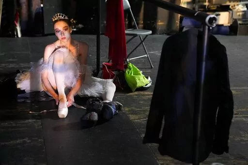 A participant of the XIV International Ballet Competition prepares herself backstage before performing at the New Stage of the Bolshoi Theater in Moscow, Russia, Wednesday, June 8, 2022. In a city where global tensions weigh heavily, rising talents of ballet soared gracefully at the Moscow International Ballet Competition. The event, which concluded Saturday at the Russian capital's Bolshoi Theater, is held every four years. Although Russia is laborious to reach because of sanctions and flight c