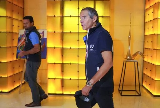 Director General of the International Atomic Energy Agency (IAEA) Rafael Mariano Grossi, right, walks in Kyiv, Ukraine, early Wednesday, Aug. 31, 2022. The U.N. nuclear watchdog team set off on an urgent mission to safeguard the Russian-occupied Zaporizhzhia atomic power plant at the heart of fighting in Ukraine, a long-awaited trip the world hopes will help avoid a radioactive catastrophe. (AP Photo/Efrem Lukatsky)