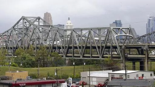 Traffic on the Brent Spence Bridge passes in front of the Cincinnati skyline while crossing the Ohio River to and from Covington, Ky., Oct. 7, 2014. According to a recent announcement by Kentucky and Ohio they will receive more than $1.63 billion in federal grants to help build a new Ohio River bridge near Cincinnati and improve the existing overloaded span there, a heavily used freight route linking the Midwest and the South. (AP Photo/Al Behrman, File)