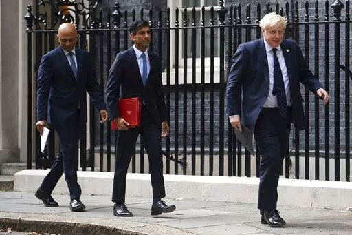 From left, British Health Secretary Sajid Javid, Chancellor of the Exchequer Rishi Sunak and Prime Minister Boris Johnson arrive at No 9 Downing Street for a media briefing on May 7, 2021. The contest to succeed British Prime Minister Boris Johnson has no single frontrunner but there are many prominent contenders.  (Toby Melville/PA via AP, file)