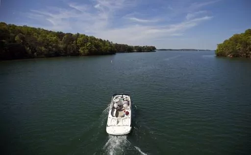 A boat passes along Lake Lanier, April 23, 2013, in Buford, Ga. Fashion designer Tameka Foster, the ex-wife of R&B singer Usher, is calling to drain Lake Lanier, Georgia's largest lake, where her son was fatally injured 11 years ago. Kile Glover, her 11-year-old son with Bounce TV chairman Ryan Glover, died in July 2012 after a personal watercraft struck the boy as he floated in an inner tube on the lake. (AP Photo/David Goldman, File)