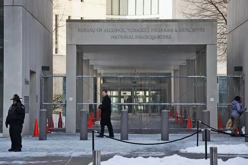 A security official walks in front of the entrance to the national headquarters of the Bureau of Alcohol, Tobacco, Firearms and Explosives on Jan. 23, 2014, in Washington. New data from the bureau shows that 68,000 illegally trafficked firearms in the U.S. came through unlicensed dealers who aren't required to perform background checks over a five year report that was released Thursday, April 4, 2024. (AP Photo/Charles Dharapak, File)