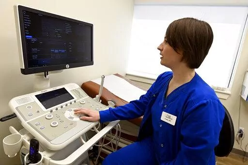 Nurse Cassie Owen demonstrates an ultrasound machine at the Portico Crisis Pregnancy Center Jan. 26, 2022, in Murfreesboro, Tenn. States that have passed ever-restrictive abortion laws also have been funneling millions of taxpayer dollars into privately operated clinics that steer women away from abortions but provide little if any health care services. (AP Photo/Mark Zaleski)